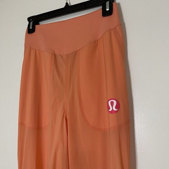 LULULEMON orange peach lightweight magnetic slit hem jogger pants 4 - Picture 3 of 8